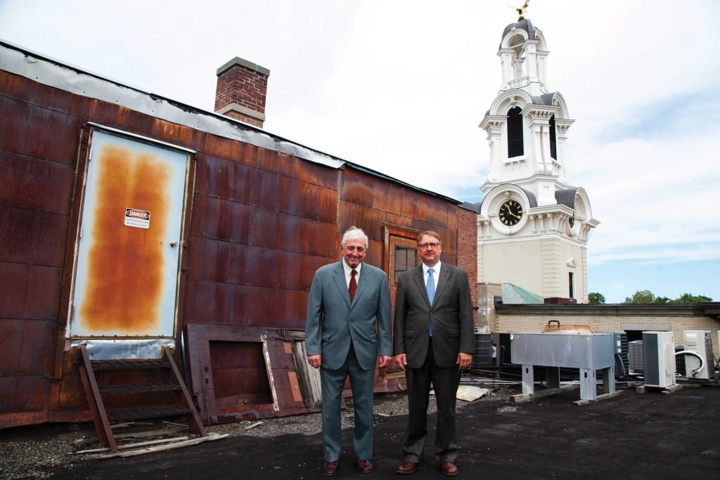 Carmine DiAdamo (left) and son William, on the roof of their building with City Hall behind them.
