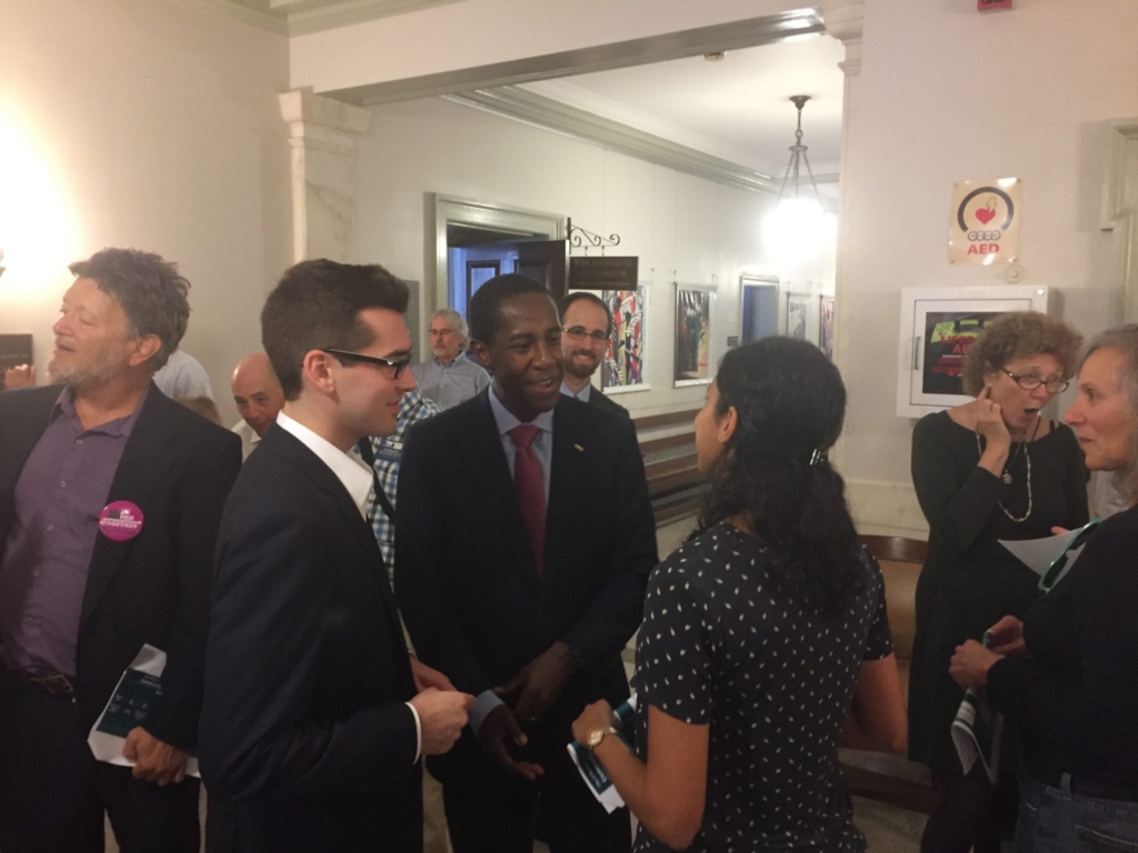 Newton Mayor Setti Warren, center, chats after his solar press conference.