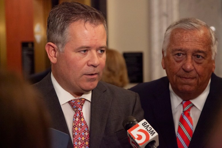 Judiciary Committee Co-chair Rep. Michael Day (left) speaks to reporters on June 12, 2024 after meeting privately with other House Democrats, including Speaker Ron Mariano (right).